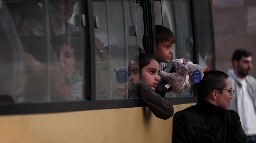 Refugees sit in a bus near a Red Cross registration centre in Goris, on Sept. 27, 2023.