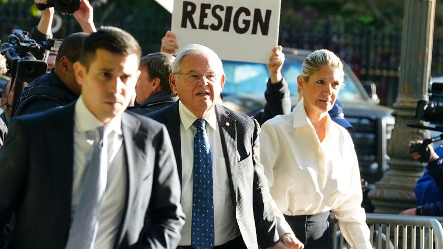 A protester outside a New York court calls on US Senator Bob Menendez to resign over corruption charges September 27, 2023