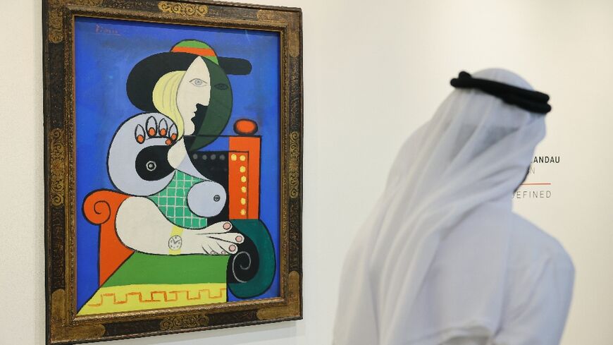 A visitor looks at Pablo Picasso's painting 'Femme a la montre' displayed for viewing at Sotheby’s Dubai, ahead of an auction in New York