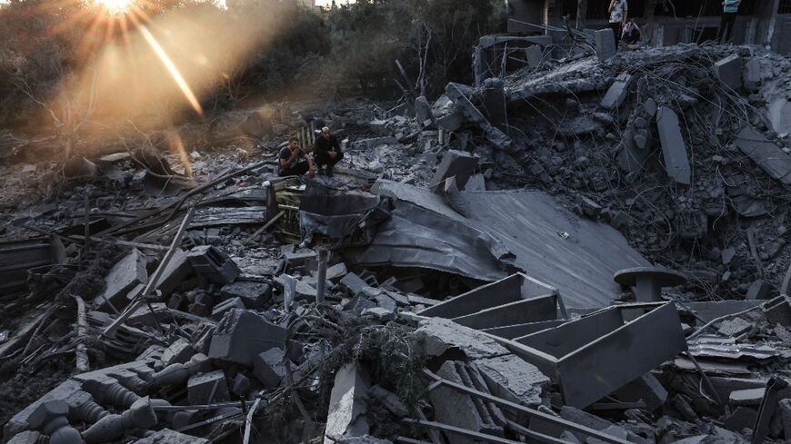 People inspect the damage to their home after Israeli strikes in the Rafah camp in southern Gaza