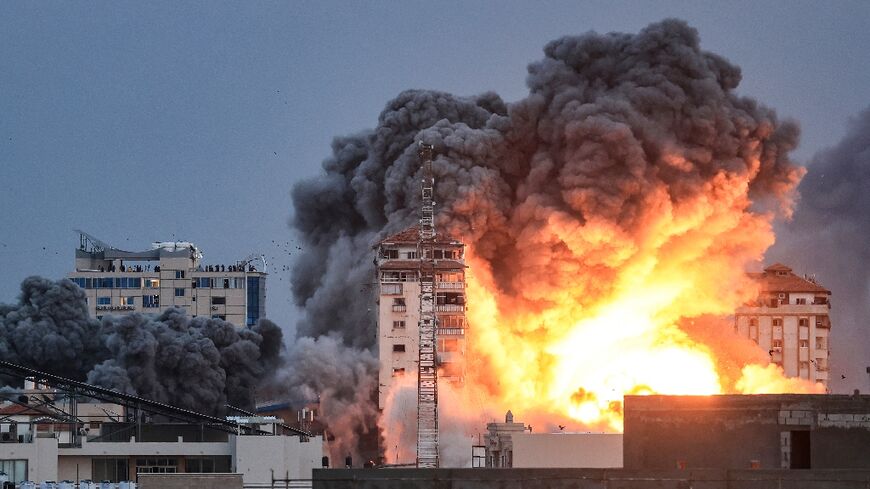 A ball of fire and smoke rise above a building in Gaza City on October 7, 2023 during Israeli air strikes