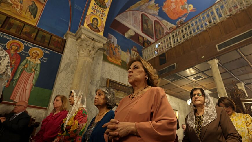 Palestinian Orthodox attend Palm Sunday mass at a church in Gaza City on April 9, 2023.