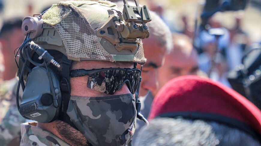 A security forces member looks on during the burial of one of three Kurdish counterterrorism officers killed the previous day in a strike by a drone that had reportedly originated in Turkey, in the city of Sulaimaniyah in the autonomous Kurdish region of northern Iraq on September 19, 2023. A senior military official in Baghdad said on September 19 that three members of the counterterrorism forces of Iraq's autonomous Kurdish region were killed and three wounded in the strike on Arbat airfield, southeast of