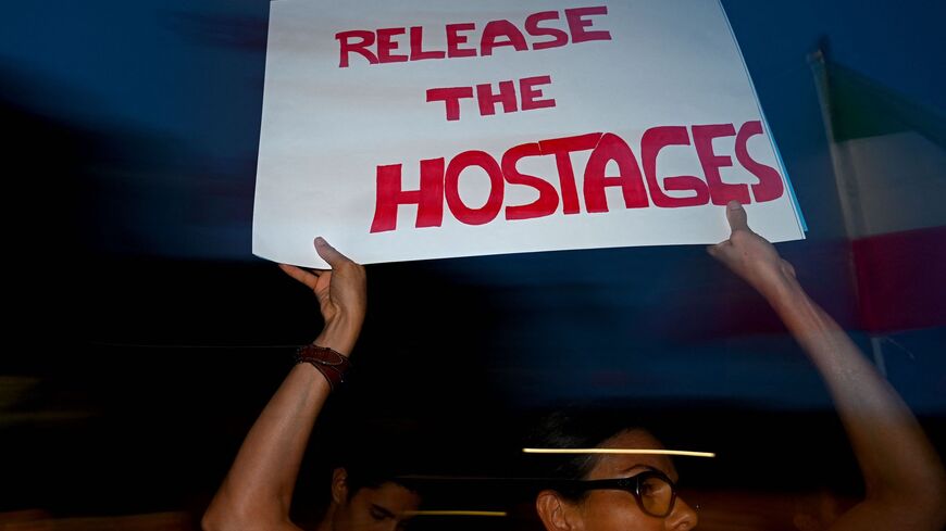 A demonstrator holds a placard during a rally in Milan on the sixth day of the war between Israel and the Palestinian Hamas movement, October 12, 2023.