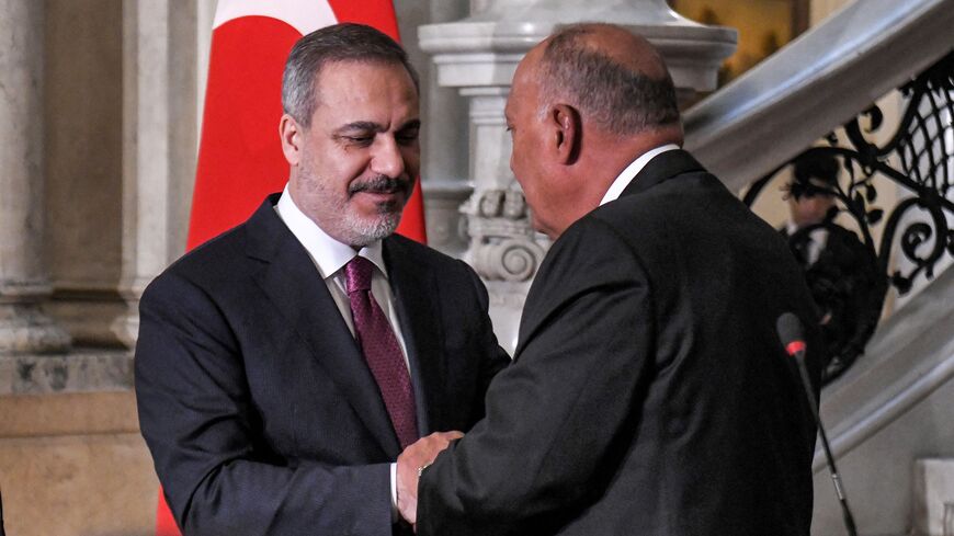 Egypt's Foreign Minister Sameh Shoukry (R) and Turkey's Foreign Minister Hakan Fidan shake hands after a joint press conference in Cairo on October 14, 2023. (Photo by Ahmed HASAN / AFP) (Photo by AHMED HASAN/AFP via Getty Images)