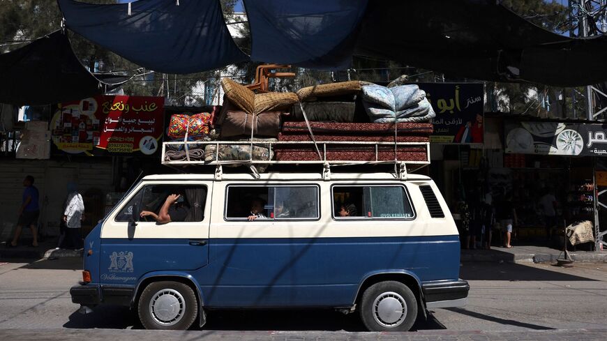 A Palestinian van carrying a family and their belongings arrives at the Rafah refugee camp, in the southern Gaza Strip on Oct. 15, 2023.