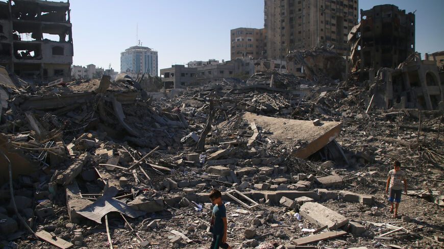 Palestinian citizens inspect the damage to their homes caused by Israeli airstrikes on Oct. 13, 2023, in Gaza City.