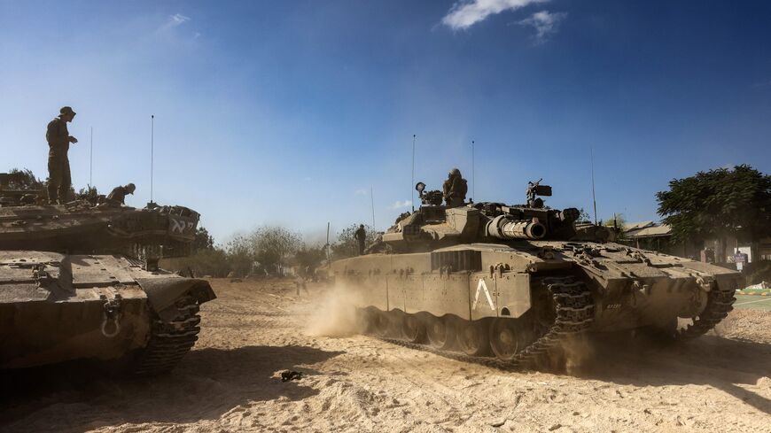 Merkava tanks roll into position outside Kibbutz Beeri near the border with the Gaza Strip on October 20, 2023, amid the ongoing battles between Israel and the Palestinian group Hamas. Thousands of people, both Israeli and Palestinians have died since October 7, 2023, after Palestinian Hamas militants based in the Gaza Strip, entered southern Israel in a surprise attack leading Israel to declare war on Hamas in Gaza on October 8. (Photo by RONALDO SCHEMIDT / AFP) (Photo by RONALDO SCHEMIDT/AFP via Getty Ima