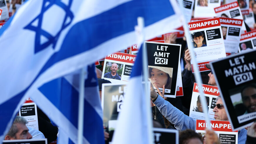 People participate in a 'Bring Them Home' solidarity rally in Trafalgar Square calling for the release of hostages held in Gaza by Hama on October 22, 2023 in London, England.