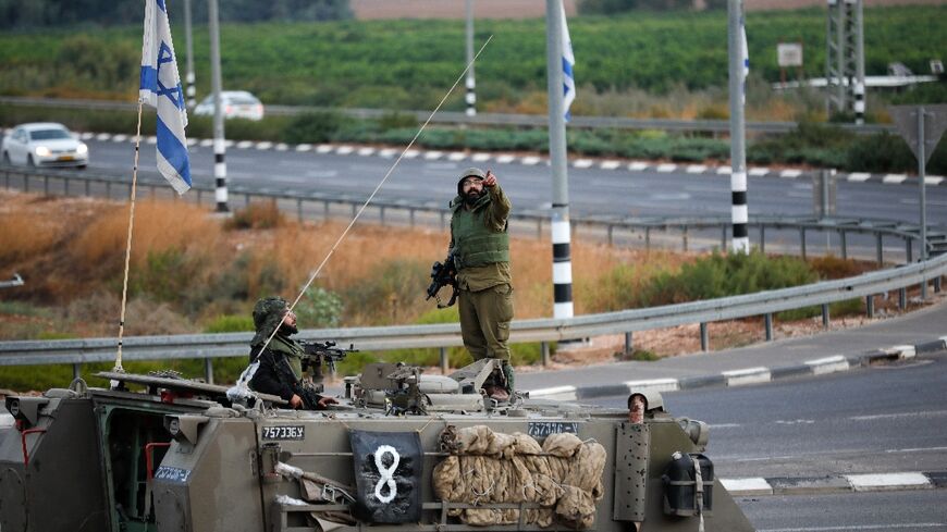 An armored Israeli vehicle is seen near the border with Lebanon on October 15, 2023