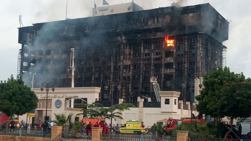 Firefighters try to extinguish the fire at a police headquarters in the Egyptian city of Ismailia