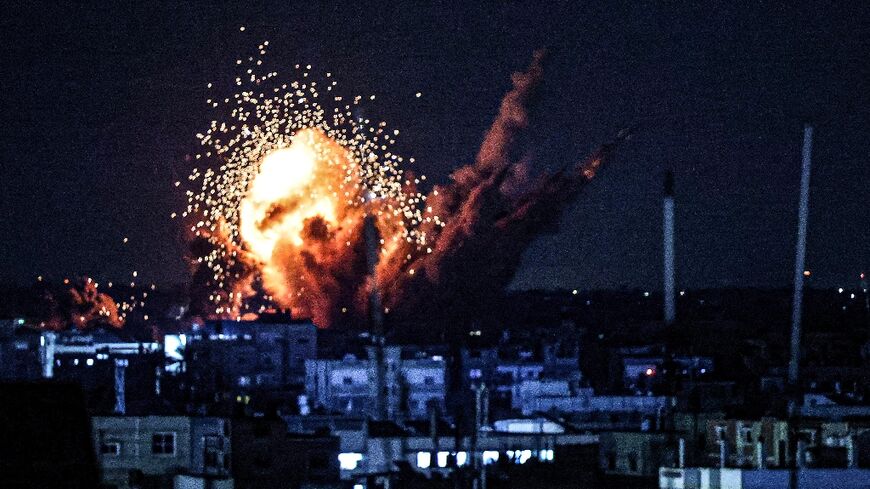 A ball of fire and smoke rise above buildings during an Israeli strike on Rafah in the southern Gaza Strip, on October 15, 2023