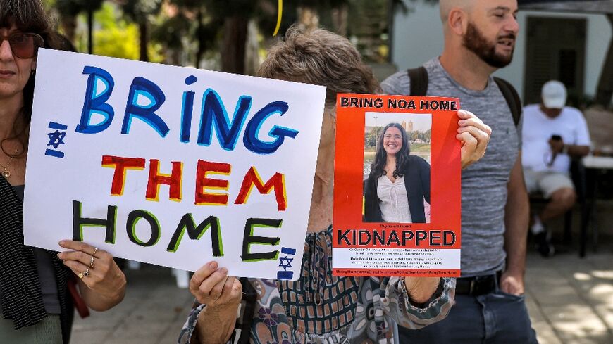 A woman in Tel Aviv holds up a photograph of one of the Israeli hostages held by Palestinian militants since the October 7 attack by Hamas