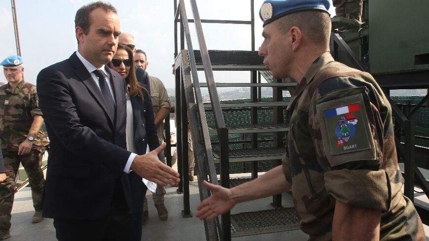 French Defence Minister Sebastien Lecornu (L) visits his country's contingent in the UN peacekeeping force in south Lebanon, telling them their mission has never been so important