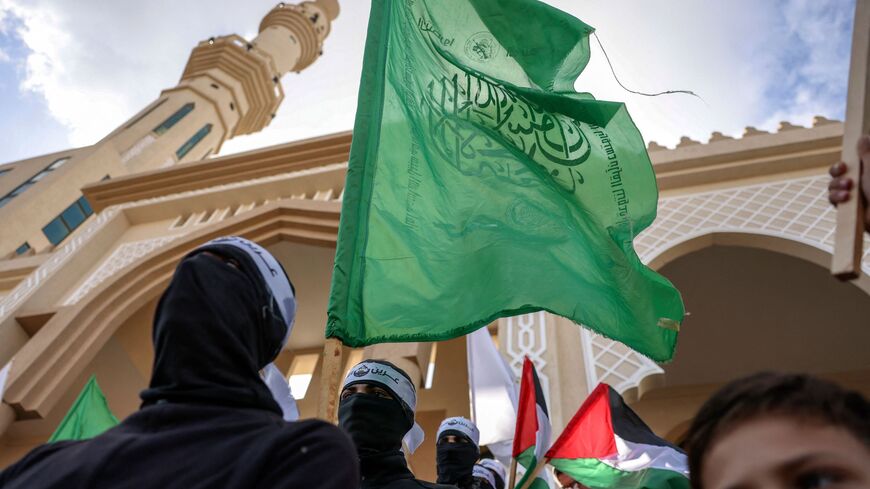 Palestinian Hamas supporters raise flags as they rally in support of the occupied West Bank and the Nablus-based Lion's Den armed group (Areen Al-Asood), following the Friday noon prayers in Gaza City, on Nov. 25, 2022.