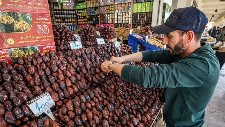 In this picture taken on April 2, 2023, a vendor arranges dates at his shop in Rabat, during the Muslim holy fasting month of Ramadan. (Photo by FADEL SENNA / AFP) (Photo by FADEL SENNA/AFP via Getty Images)