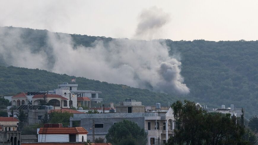 Smoke billows following Israeli artillery bombing on the outskirts of the Lebanese border village of Aita al-Shaab, from an Israeli military position overlooking the area, Oct. 9, 2023.