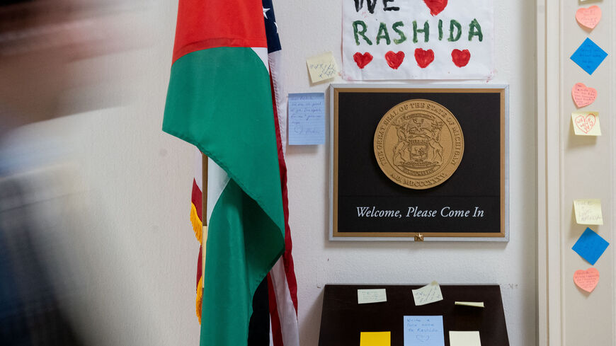 A person walks past signs and notes left outside the office of US Representative Rashida Tlaib, Democrat of Michigan, on Capitol Hill in Washington, DC, November 8, 2023. The US House of Representatives voted on November 7 to censure Tlaib, the only Palestinian-American in Congress, over her comments on the Israel-Hamas war, US media reported. The Democrat was censured by Republicans and some members of her own party in a resolution that passed by 234 votes to 188. (Photo by Stefani Reynolds / AFP) (Photo b