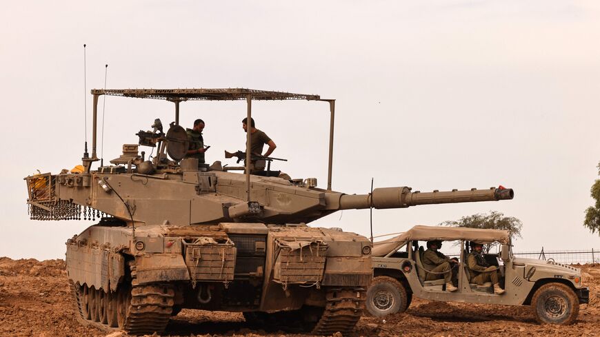 Israeli soldiers wait in their vehicle in an area in Southern Israel near the Gaza Strip on November 22, 2023 amid the ongoing battles between Israel and the Palestinian Hamas movement. (Photo by JACK GUEZ / AFP) (Photo by JACK GUEZ/AFP via Getty Images)