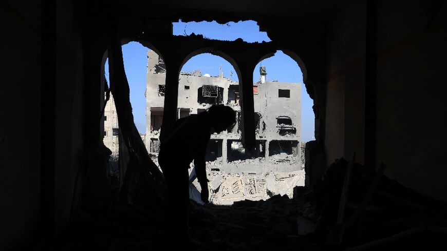 A child inspects the damage at the Nuseirat refugee camp in the central Gaza Strip