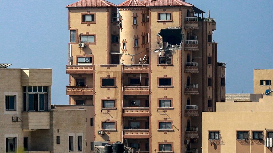 A gaping hole is seen in the side of the building that houses the bureau of Agence France-Presse in Gaza City