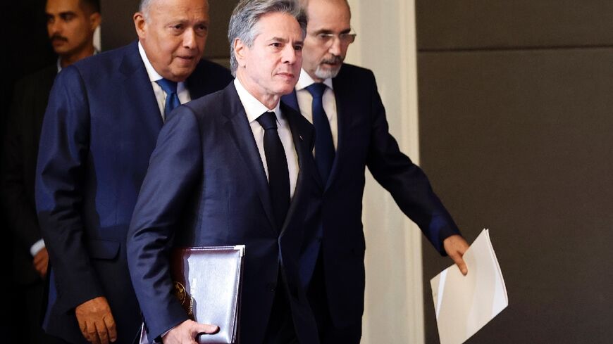 US Secretary of State Antony Blinken (C) arrives for a joint news conference in Amman with his Egyptian and Jordanian counterparts Sameh Shoukry (L) and Ayman Safadi