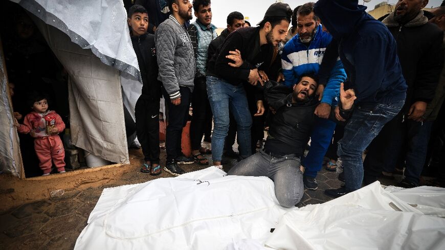 Mourners at a mass funeral in southern Gaza for Palestinians killed in an Israeli strike on Al-Maghazi refugee camp