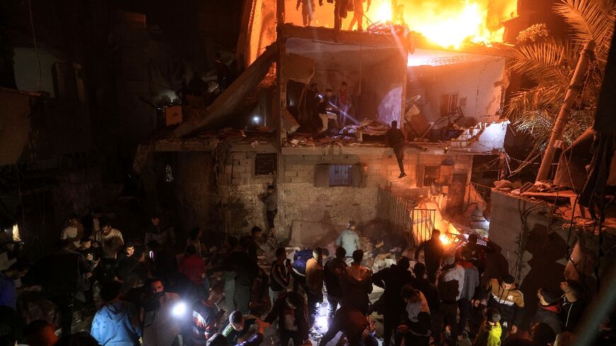 People search for victims in the rubble of a building after a strike on Rafah in southern Gaza