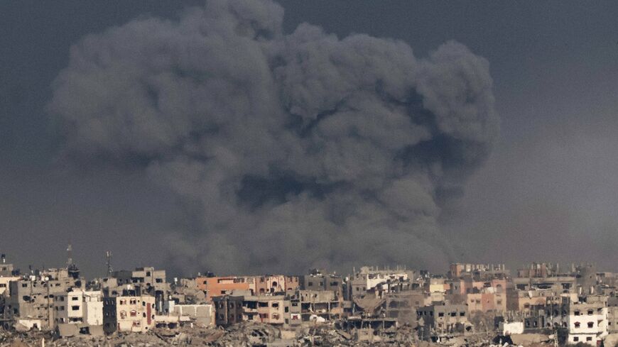 A picture taken from southern Israel near the border with the Gaza Strip on December 12, 2023 shows smoke billowing during Israeli bombardment of the Palestinian territory 