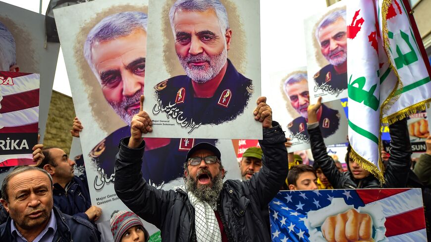 TOPSHOT - Protesters hold pictures of Iranian commander Qasem Soleimani, during a demonstration outside the US consulate in Istanbul, on January 5, 2020, two days after top Iranian commander Qasem Soleimani was killed by a US drone strike. - A US drone strike killed top Iranian commander Qasem Soleimani at Baghdad's international airport on January 3, dramatically heightening regional tensions and prompting arch enemy Tehran to vow "revenge". (Photo by Yasin AKGUL / AFP) (Photo by YASIN AKGUL/AFP via Getty