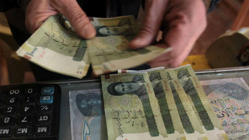 TO GO WITH AFP STORY BY SALAM FARAJ An Iraqi money dealer counts Iranian rial banknotes bearing a portrait of the late founder of the Islamic Republic of Iran, Ayatollah Ruhollah Khomeini, at an exchange office in Baghdad on February 3, 2012. Tens of thousands of Iranian visitors have been finding difficulty in using the Iranian currency in Iraq due to a depreciation of the rial against the dollar. AFP PHOTO/ ALI AL-SAADI (Photo credit should read ALI AL-SAADI/AFP/GettyImages)