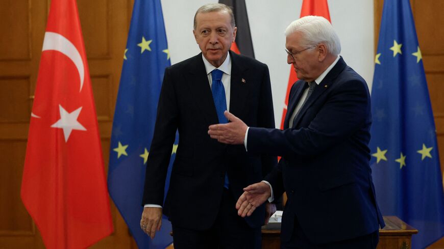 TOPSHOT - German President Frank-Walter Steinmeier (R) gestures after Turkish President Recep Tayyip Erdogan signed a guest book during his visit at Bellevue presidential palace in Berlin on November 17, 2023. (Photo by Odd ANDERSEN / AFP) (Photo by ODD ANDERSEN/AFP via Getty Images)