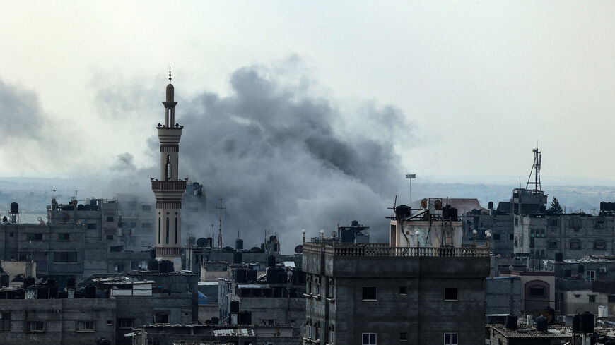 Smoke rises above buildings during an Israeli strike on Rafah near the border with Egypt, in the southern Gaza Strip on December 1, 2023, after battles resumed between Israel and the Hamas movement. A temporary truce between Israel and Hamas expired on December 1, with the Israeli army saying combat operations had resumed, accusing Hamas of violating the operational pause. (Photo by SAID KHATIB / AFP) (Photo by SAID KHATIB/AFP via Getty Images)