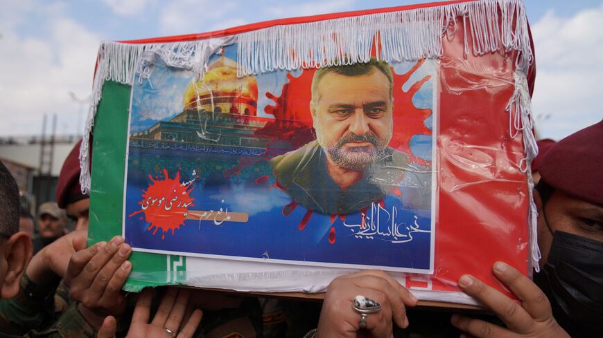 Honor guards carry the coffin of Sayyed Razi Mousavi.