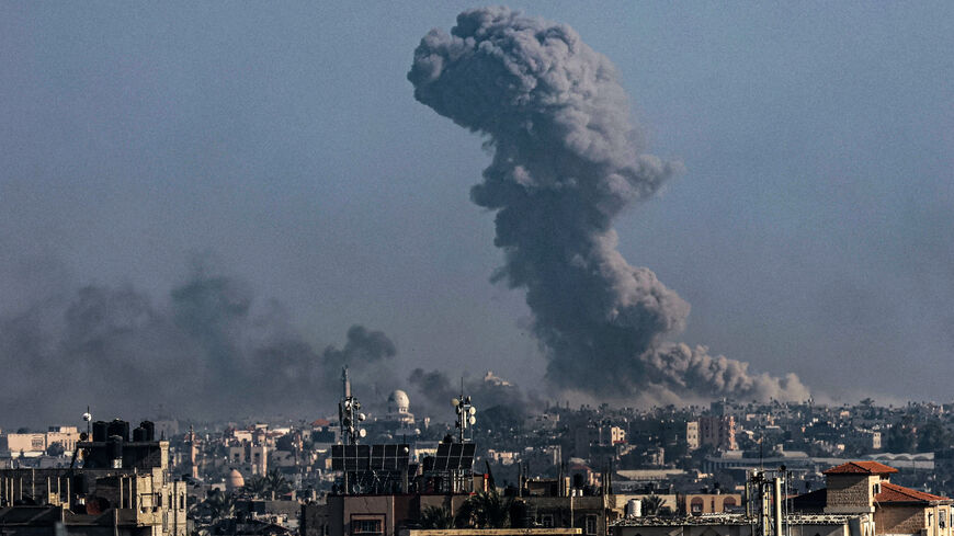 A picture taken from Rafah shows smoke billowing over Khan Yunis in the southern Gaza Strip during Israeli bombardment on Dec. 30, 2023.