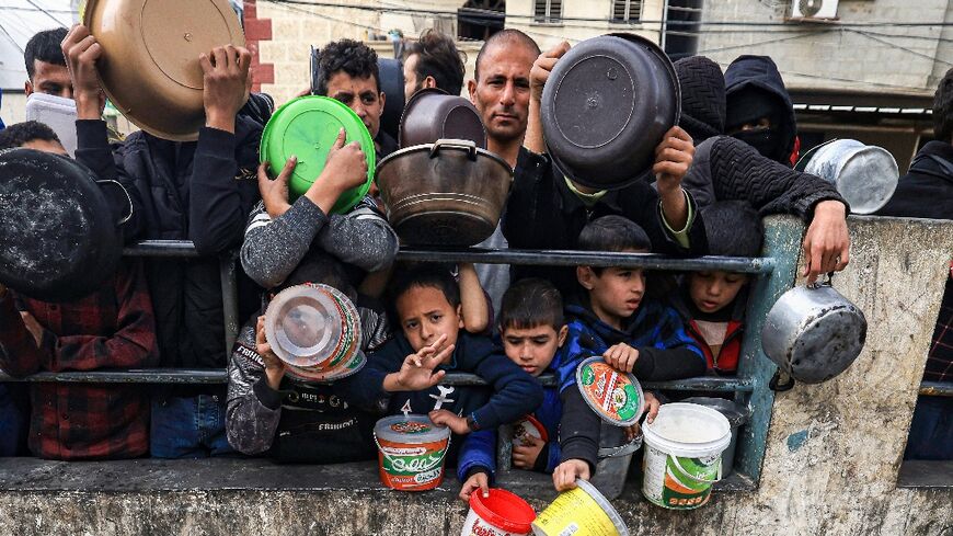 Many children are among those queueing, desparate for food