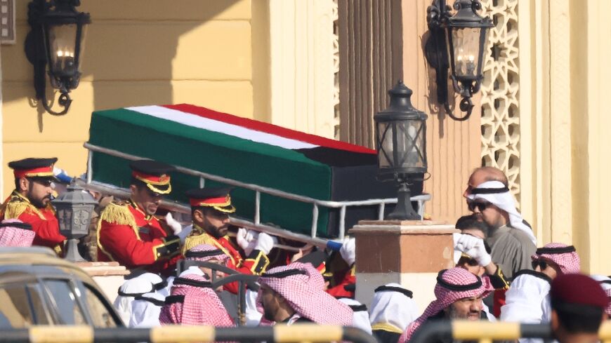 The coffin of Kuwait's late Emir Sheikh Nawaf al-Ahmad Al-Sabah is carried out of the Bilal bin Rabah Mosque in Kuwait City ahead of burial during his funeral