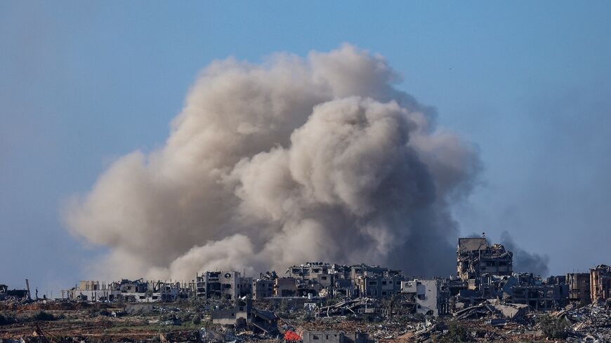 A picture taken from southern Israel on the border with the Gaza Strip shows smoke billowing over northern Gaza on December 16, 2023