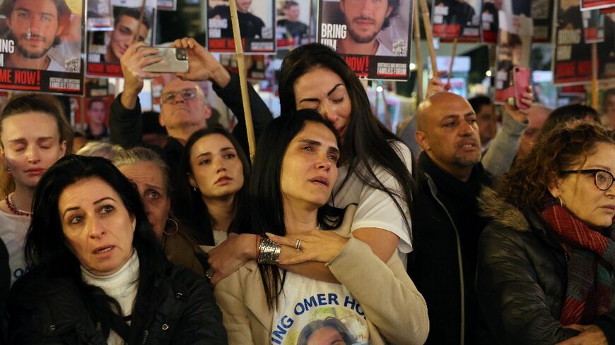 Relatives of Israeli hostages held by Palestinian militants in Gaza join a Tel Aviv rally demanding an end to their ordeal now entering its 100th day