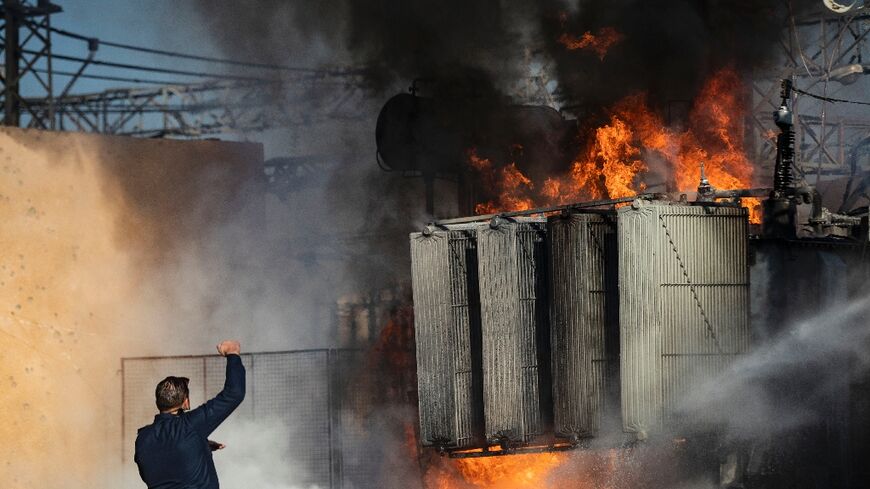 Kurdish Syrian firemen put out a blaze at a power station in Qamishli which was reportedly targeted by Turkish drones