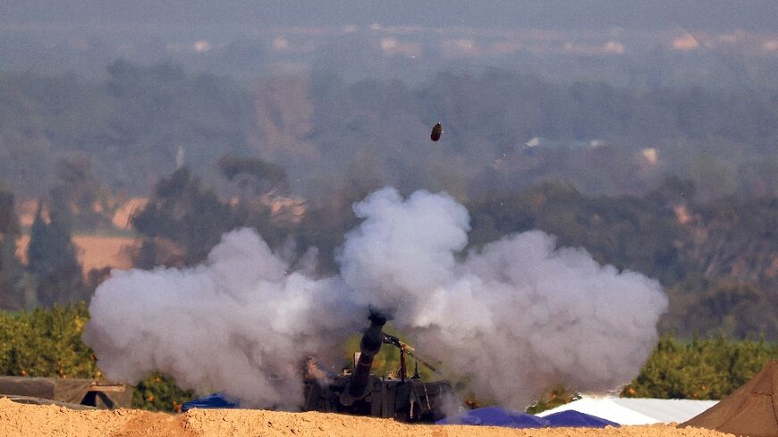 An Israeli army self-propelled howitzer fires from southern Israel toward the Gaza Strip in the battle with Hamas militants