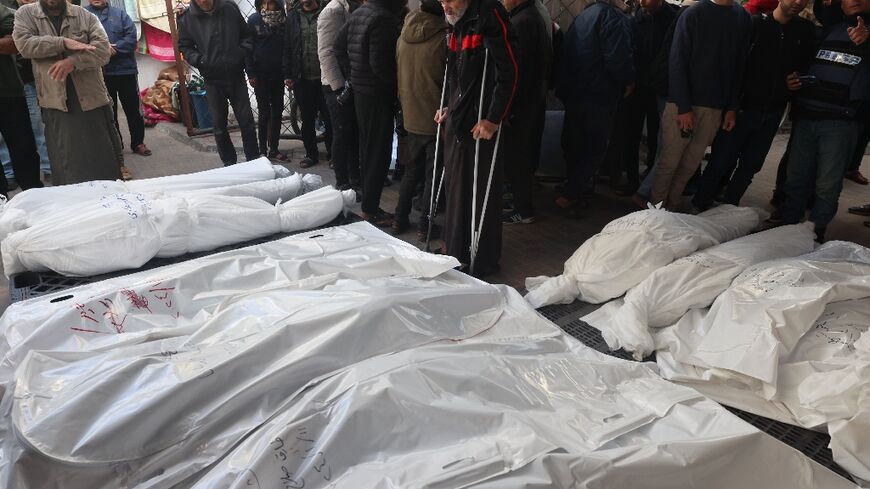 Palestinians in Rafah, the southern Gaza strip, mourn over bodies killed in Israeli bombardment 