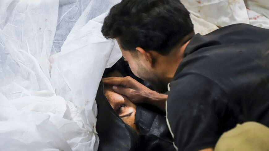 A man mourns a victim, at a hospital in the southern Iranian city of Kerman 