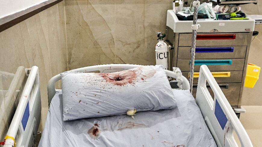 A bullet hole is visible in the blood-soaked pillow of a hospital bed  after a deadly raid by Israeli undercover agents on the Ibn Sina Hospital in the West Bank city of Jenin