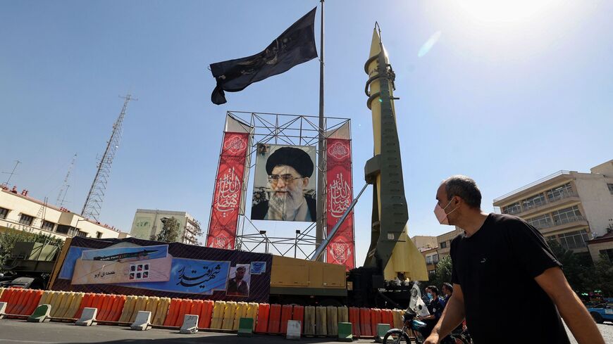 A Shahab-3 surface-to-surface missile is displayed next to a portrait of Iranian Supreme Leader Ayatollah Ali Khamenei at a street exhibition by Iran's army and paramilitary Revolutionary Guard force to celebrate "Defense Week", marking the 41st anniversary of the start of 1980-88 Iran-Iraq war, at the Baharestan Square in Tehran, on Sept. 25, 2021.