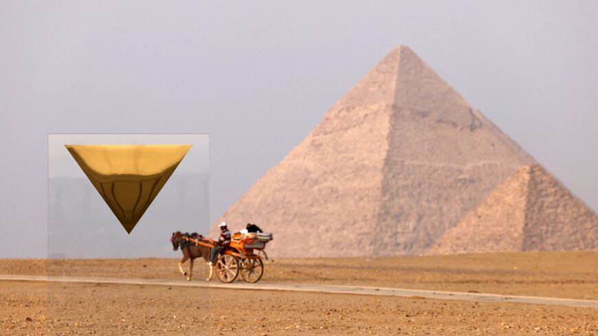 Tourists ride in a horse-drawn carriage near the art installation "Temple" by French artist Stephan Breuer and the Pyramid of Menkaure or Menkheres (front) and the Pyramd of Khafre or Chephren (behind) during the third edition of the "Forever is Now" art exhibition by Art d'Egypte at the Giza pyramids necropolis on October 28, 2023. (Photo by Khaled DESOUKI / AFP) / RESTRICTED TO EDITORIAL USE - MANDATORY MENTION OF THE ARTIST UPON PUBLICATION - TO ILLUSTRATE THE EVENT AS SPECIFIED IN THE CAPTION (Photo by 