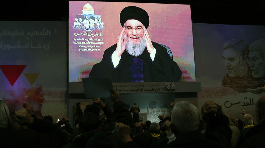 People watch the televised speech of Lebanon's Hezbollah chief Hasan Nasrallah to mark the anniversary of the killing of slain top Iranian commander Qasem Soleimani, in a Beirut's southern suburb on January 3, 2024. Twin bomb blasts killed at least 103 people in Iran, ripping through a crowd commemorating Revolutionary Guards general Qasem Soleimani four years after his death in a US strike, state media reported. (Photo by ANWAR AMRO / AFP) (Photo by ANWAR AMRO/AFP via Getty Images)