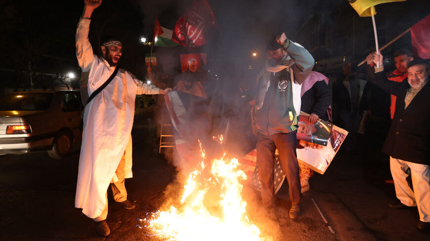 Iranian protesters burn an Israeli and a US flag during a demonstration in solidarity with the Palestinian people and Iran-backed Yemeni rebels following US and British forces strikes on Huthi rebel-held cities in Yemen, in front of the British embassy in Tehran on January 12, 2024 amid the ongoing battles between Israel and the militant Hamas group in Gaza. US and British forces struck rebel-held Yemen early on January 12, after weeks of disruptive attacks on Red Sea shipping by the Iran-backed Huthis who 