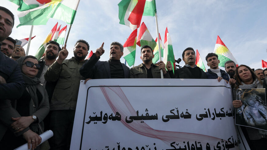 Protesters hold a banner and Kurdish flags during a demonstration outside the United Nations (UN) office, a day after several areas in the city were hit by a missile attack launched by Iran's Islamic Revolutionary Guard Corps (IRGC), in Erbil, the capital of Iraq's northern autonomous Kurdish region early on Jan. 16, 2024.