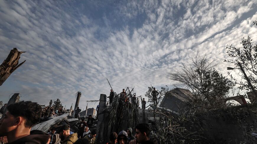 Palestinians stand amidst the rubble of a mosque and buildings which collapsed during Israeli bombardment around the town city of Rafah southern Gaza Strip on January 24, 2024, amid ongoing battles between Israel and the Palestinian militant group Hamas. (Photo by AFP) (Photo by -/AFP via Getty Images)